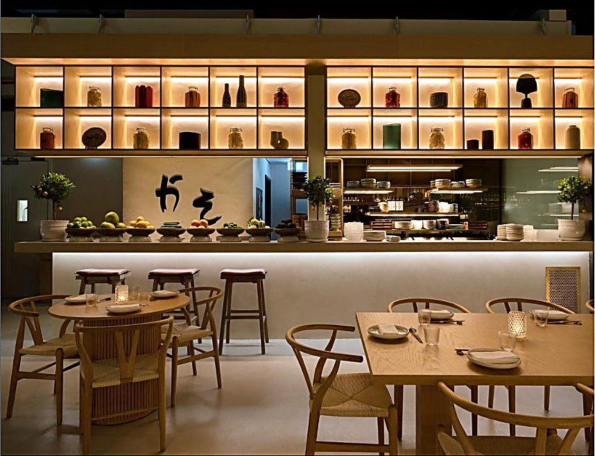 Backlit display bar with timber stools and shelved glassware